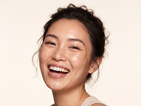 Woman smiling after a wrinkle relaxer treatment at HoneMD med spa
