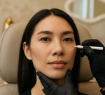 NP injector marking cheekbone treatment zone during cheek filler consultation at HoneMD Torrance