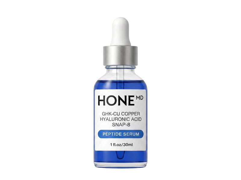 A blue HoneMD GHK-Cu copper, hyaluronic acid and SNAP-8 peptide serum dropper bottle, 1 fl oz / 30 ml, standing on white